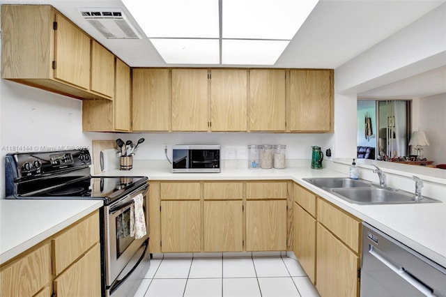 9510 Seagrape Dr Unit 101, Davie, FL 33324 - kitchen featuring appliances with stainless steel finishes, a sink, light countertops, light tile patterned flooring, and light brown cabinets