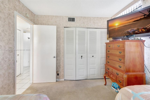 9510 Seagrape Dr Unit 101, Davie, FL 33324 - bedroom featuring a closet, carpet flooring, and tile patterned flooring