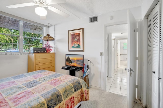 9510 Seagrape Dr Unit 101, Davie, FL 33324 - bedroom with light colored carpet, light tile patterned floors, a closet, and a ceiling fan