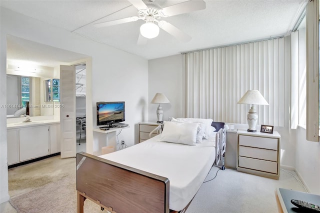 9510 Seagrape Dr Unit 101, Davie, FL 33324 - bedroom with light colored carpet, ensuite bathroom, a ceiling fan, baseboards, and a sink