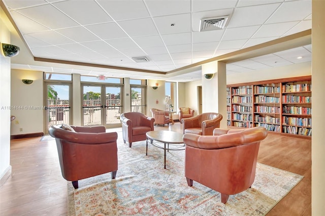 9510 Seagrape Dr Unit 101, Davie, FL 33324 - living area with a drop ceiling, wood finished floors, and baseboards