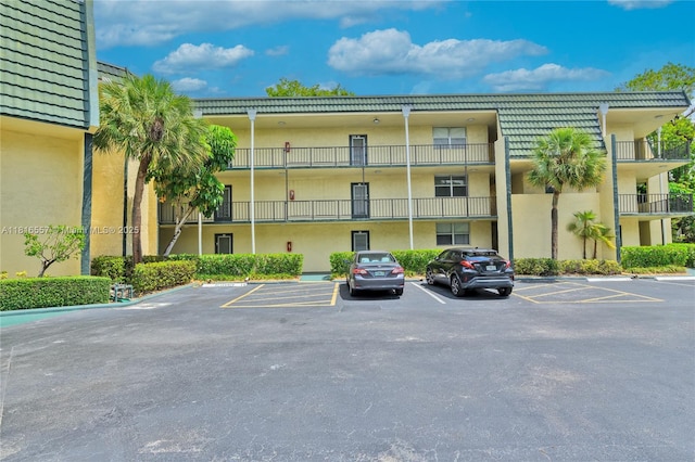 9091 Lime Bay Blvd Unit 211, Tamarac, FL 33321 - view of building exterior with uncovered parking