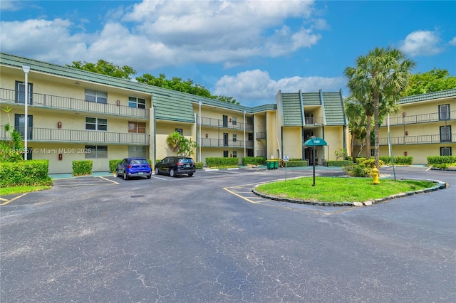 9091 Lime Bay Blvd Unit 211, Tamarac, FL 33321 - view of building exterior with uncovered parking