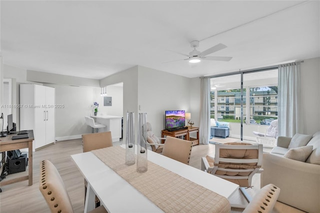 9091 Lime Bay Blvd Unit 211, Tamarac, FL 33321 - dining space featuring light wood-style flooring, a ceiling fan, baseboards, and electric panel