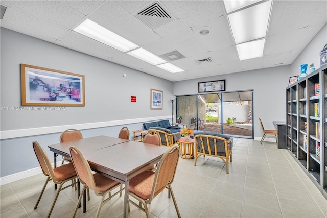 9091 Lime Bay Blvd Unit 211, Tamarac, FL 33321 - dining room featuring a paneled ceiling, tile patterned flooring, and baseboards