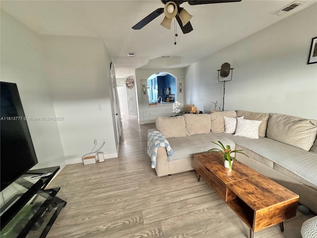 120 SW 109th Ave Unit 3, Sweetwater, FL 33174 - living area featuring wood finished floors, a ceiling fan, arched walkways, and baseboards