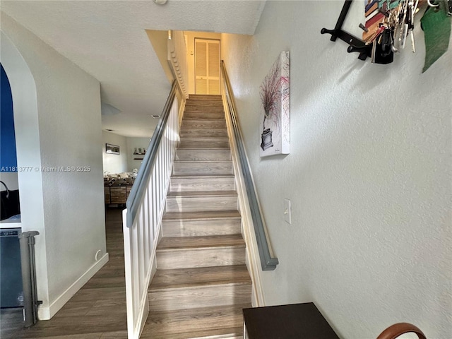 120 SW 109th Ave Unit 3, Sweetwater, FL 33174 - staircase with arched walkways, wood finished floors, baseboards, and a textured wall