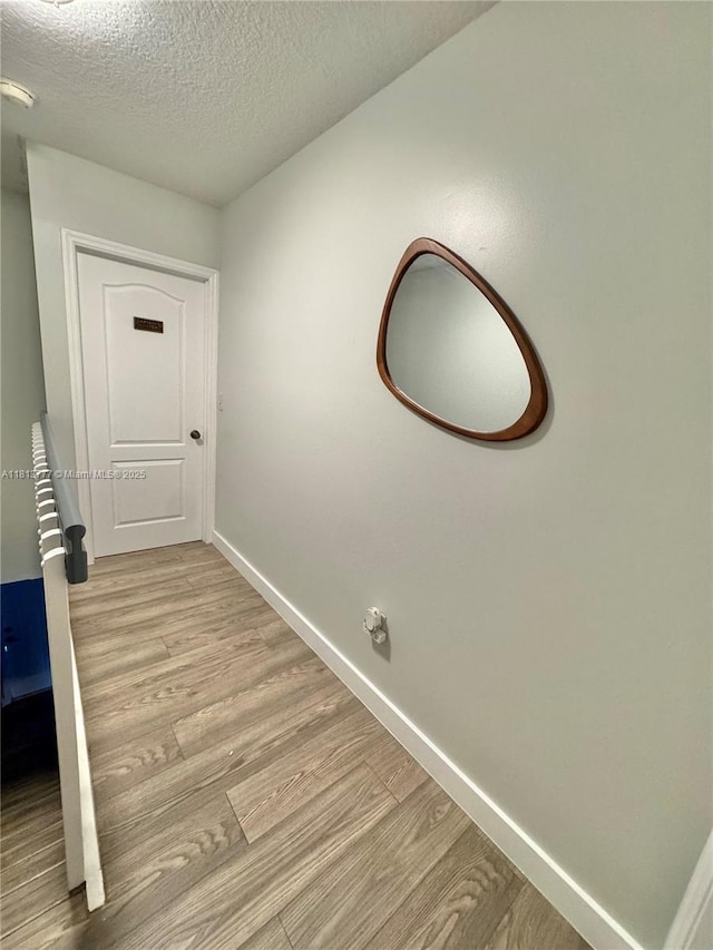120 SW 109th Ave Unit 3, Sweetwater, FL 33174 - hallway with light wood-style floors, baseboards, and a textured ceiling
