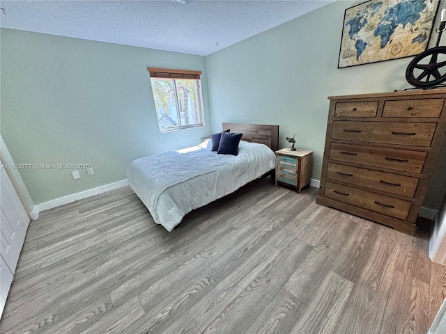 120 SW 109th Ave Unit 3, Sweetwater, FL 33174 - bedroom with wood finished floors, baseboards, and a textured ceiling