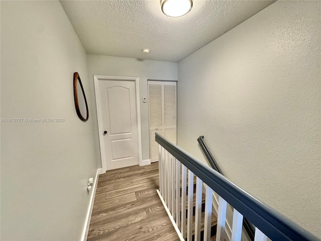 120 SW 109th Ave Unit 3, Sweetwater, FL 33174 - hall with an upstairs landing, a textured ceiling, wood finished floors, and baseboards