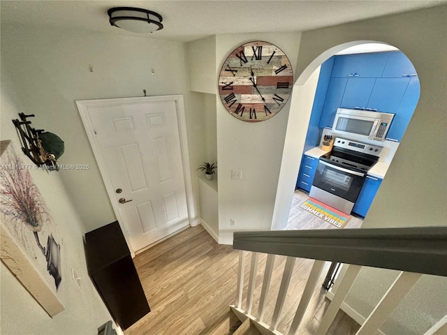 120 SW 109th Ave Unit 3, Sweetwater, FL 33174 - foyer entrance featuring light wood-style floors, arched walkways, and baseboards