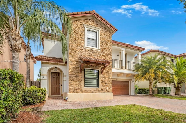 628 SE 37th Pl, Homestead, FL 33033 - mediterranean / spanish-style house featuring a tiled roof, stone siding, an attached garage, and decorative driveway