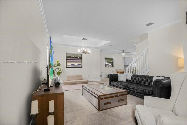 628 SE 37th Pl, Homestead, FL 33033 - living room featuring stairway, crown molding, a chandelier, ceiling fan, and a tray ceiling