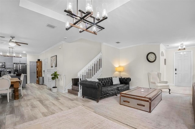 628 SE 37th Pl, Homestead, FL 33033 - living area featuring stairs, a chandelier, a ceiling fan, light wood-style floors, and crown molding