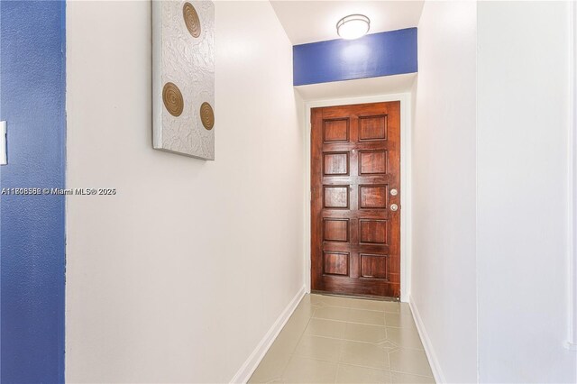 430 Golden Isles Dr Unit 301, Hallandale Beach, FL 33009 - hallway with tile patterned flooring and baseboards