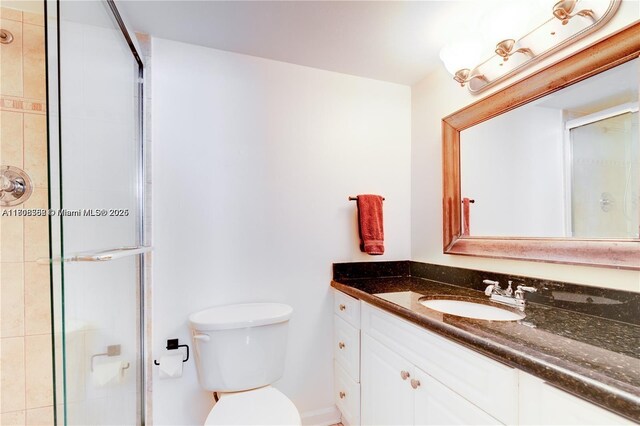 430 Golden Isles Dr Unit 301, Hallandale Beach, FL 33009 - bathroom with vanity, a tile shower, and toilet