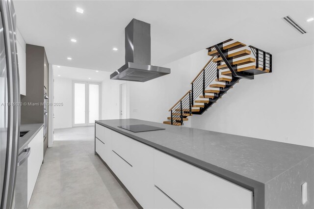 3122 Carter St, Miami, FL 33133 - kitchen featuring ventilation hood, modern cabinets, black electric stovetop, finished concrete flooring, and white cabinets