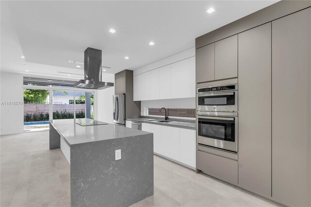 3122 Carter St, Miami, FL 33133 - kitchen featuring modern cabinets, stainless steel appliances, island exhaust hood, a center island, and recessed lighting