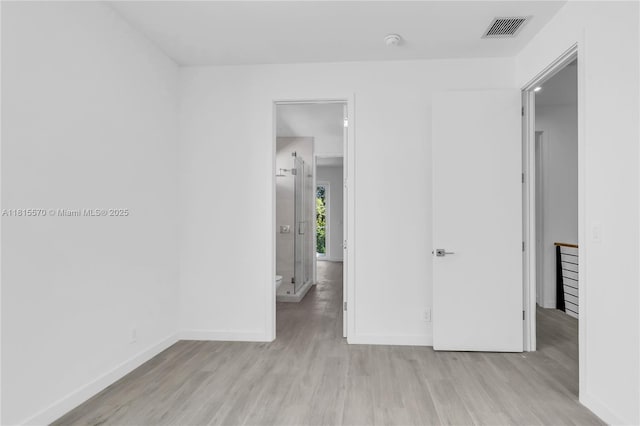 3122 Carter St, Miami, FL 33133 - unfurnished bedroom featuring light wood finished floors and baseboards