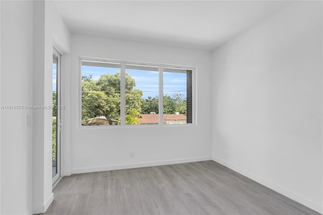 3122 Carter St, Miami, FL 33133 - spare room with healthy amount of natural light, light wood-type flooring, and baseboards