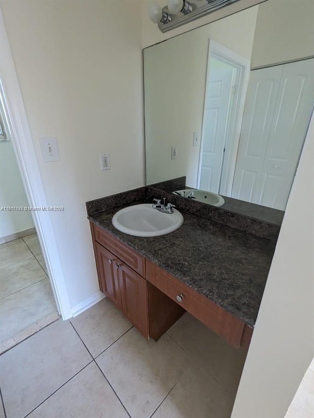15201 Glenmoor Dr Unit 15201, West Palm Beach, FL 33409 - bathroom with vanity, tile patterned flooring, and baseboards