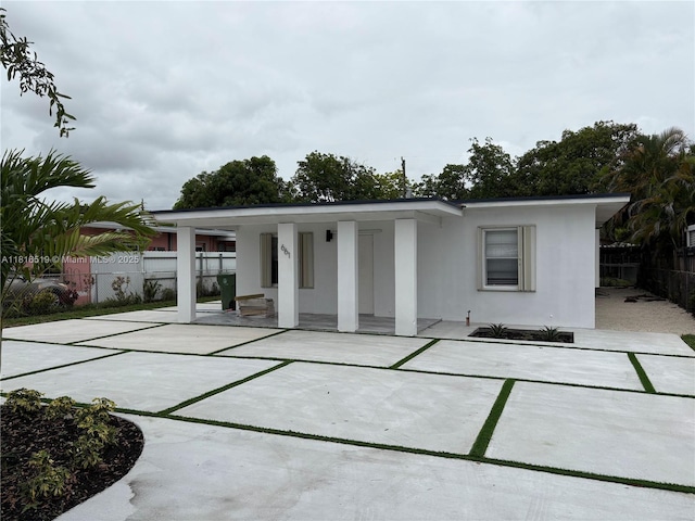 661 E 44th St, Hialeah, FL 33013 - rear view of house featuring stucco siding and covered porch