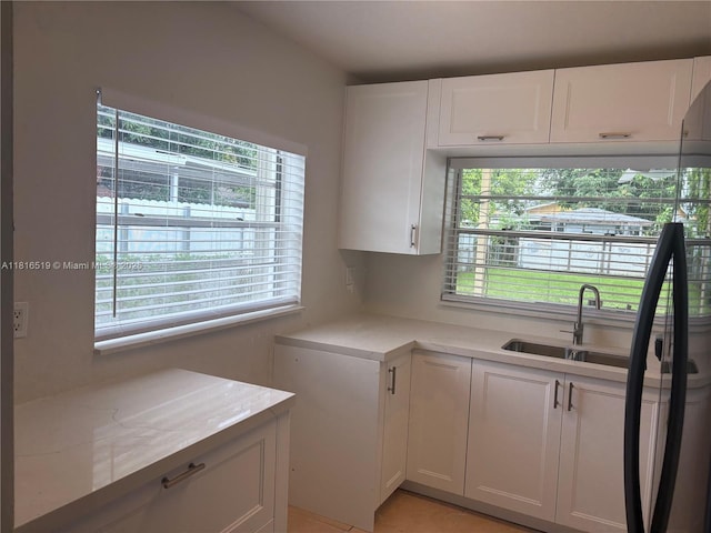 661 E 44th St, Hialeah, FL 33013 - kitchen featuring white cabinets and light stone countertops