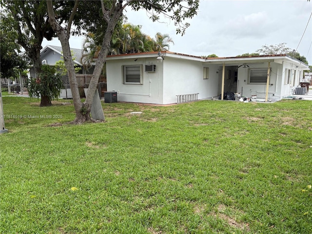 661 E 44th St, Hialeah, FL 33013 - rear view of house with stucco siding and a wall unit AC
