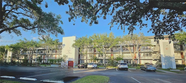 1401 SW 134th Way Unit 412C, Pembroke Pines, FL 33027 - view of building exterior with uncovered parking