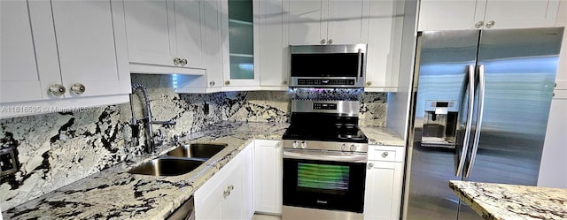 1401 SW 134th Way Unit 412C, Pembroke Pines, FL 33027 - kitchen featuring appliances with stainless steel finishes, white cabinets, and backsplash