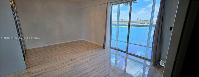 1401 SW 134th Way Unit 412C, Pembroke Pines, FL 33027 - empty room featuring wood finished floors and a water view