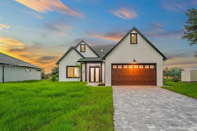 4308 3rd St SW, Lehigh Acres, FL 33976 - modern farmhouse with an attached garage, decorative driveway, a front yard, and board and batten siding