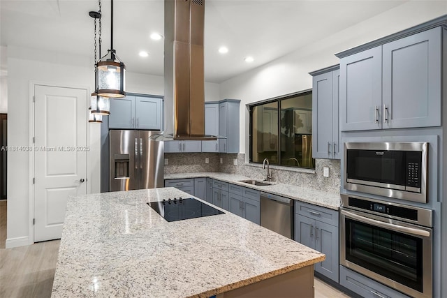 4308 3rd St SW, Lehigh Acres, FL 33976 - kitchen featuring appliances with stainless steel finishes, island range hood, a kitchen island, light stone countertops, and recessed lighting