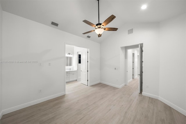 4308 3rd St SW, Lehigh Acres, FL 33976 - unfurnished bedroom featuring light wood finished floors, vaulted ceiling, baseboards, connected bathroom, and a ceiling fan