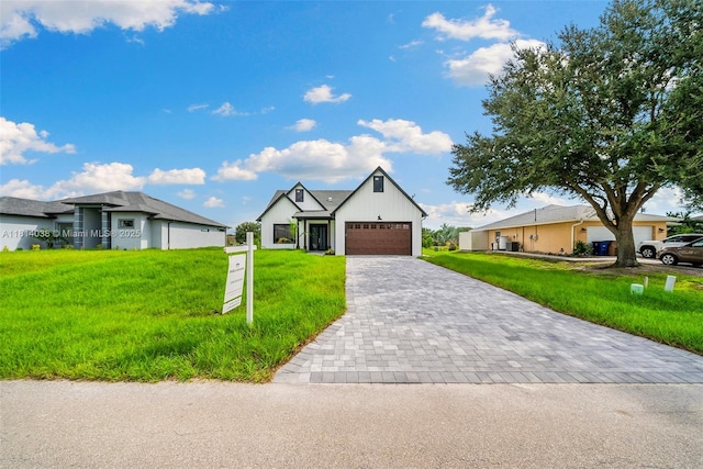4308 3rd St SW, Lehigh Acres, FL 33976 - view of front of home featuring decorative driveway, a front yard, and a garage