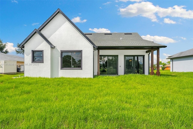 4308 3rd St SW, Lehigh Acres, FL 33976 - back of house with stucco siding and a yard