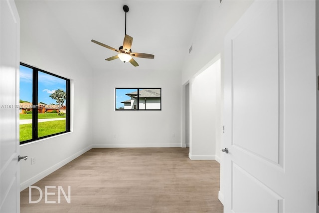 4308 3rd St SW, Lehigh Acres, FL 33976 - spare room featuring healthy amount of natural light, light wood-style flooring, a ceiling fan, lofted ceiling, and baseboards