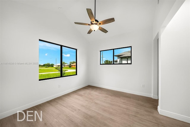 4308 3rd St SW, Lehigh Acres, FL 33976 - spare room with wood finished floors, baseboards, ceiling fan, and high vaulted ceiling