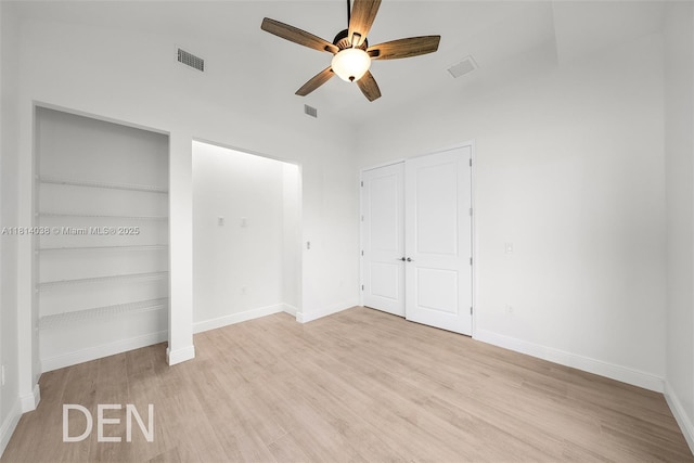 4308 3rd St SW, Lehigh Acres, FL 33976 - unfurnished bedroom featuring two closets, light wood finished floors, baseboards, and a ceiling fan