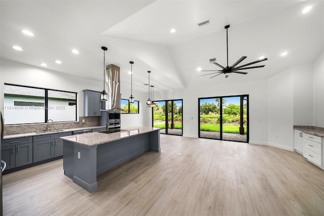 4308 3rd St SW, Lehigh Acres, FL 33976 - kitchen featuring gray cabinets, a sink, a center island, healthy amount of natural light, and recessed lighting