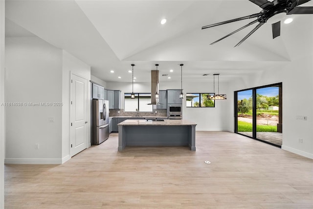4308 3rd St SW, Lehigh Acres, FL 33976 - kitchen with appliances with stainless steel finishes, gray cabinetry, baseboards, a kitchen island, and lofted ceiling