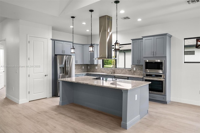 4308 3rd St SW, Lehigh Acres, FL 33976 - kitchen featuring appliances with stainless steel finishes, island range hood, light wood-style flooring, a center island, and recessed lighting