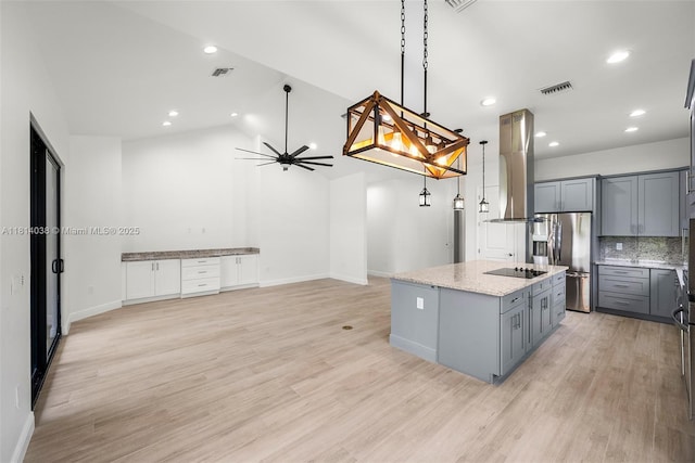 4308 3rd St SW, Lehigh Acres, FL 33976 - kitchen featuring stainless steel fridge, gray cabinetry, island range hood, a kitchen island with sink, and black electric cooktop