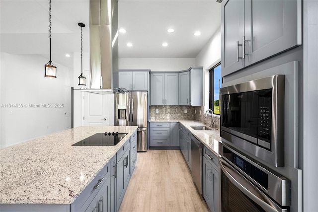 4308 3rd St SW, Lehigh Acres, FL 33976 - kitchen with appliances with stainless steel finishes, gray cabinets, a sink, light stone counters, and backsplash