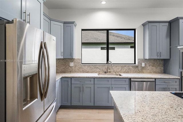 4308 3rd St SW, Lehigh Acres, FL 33976 - kitchen featuring stainless steel appliances, a sink, tasteful backsplash, gray cabinets, and recessed lighting