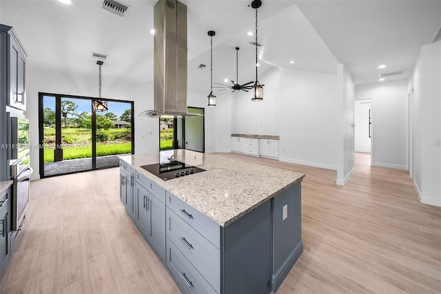 4308 3rd St SW, Lehigh Acres, FL 33976 - kitchen with appliances with stainless steel finishes, light stone counters, high vaulted ceiling, hanging light fixtures, and a center island