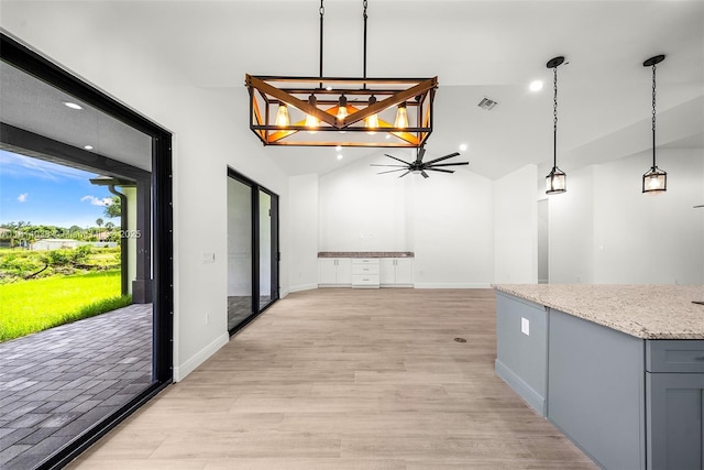4308 3rd St SW, Lehigh Acres, FL 33976 - kitchen featuring lofted ceiling, gray cabinets, light stone countertops, decorative light fixtures, and recessed lighting