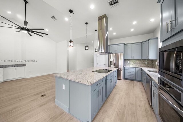 4308 3rd St SW, Lehigh Acres, FL 33976 - kitchen with black appliances, island exhaust hood, decorative backsplash, light stone counters, and a center island