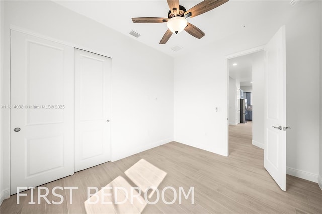 4308 3rd St SW, Lehigh Acres, FL 33976 - unfurnished bedroom featuring light wood-type flooring, a closet, baseboards, a ceiling fan, and recessed lighting