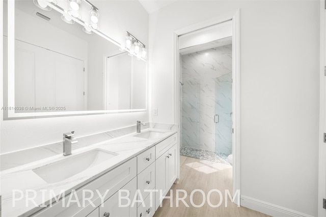4308 3rd St SW, Lehigh Acres, FL 33976 - full bathroom with a marble finish shower, double vanity, and wood finished floors